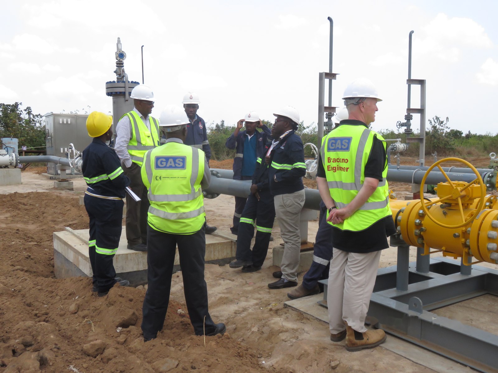 Engineers gathered around the pressure reduction skid during a site briefing